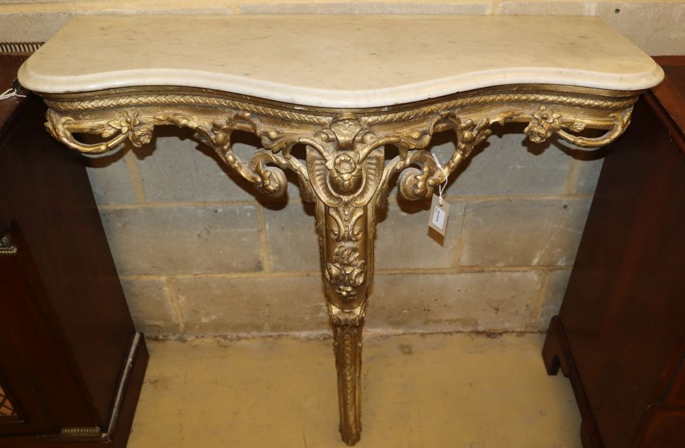 A 19th century French carved giltwood and gesso console table with serpentine marble top, W.94cm